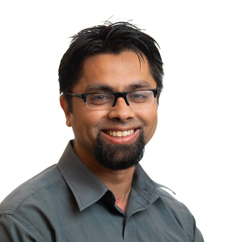 Photo of a smiling man with glasses