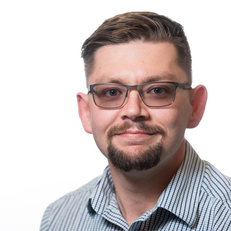 Fayette in blue and white strip shirt with white background. 
