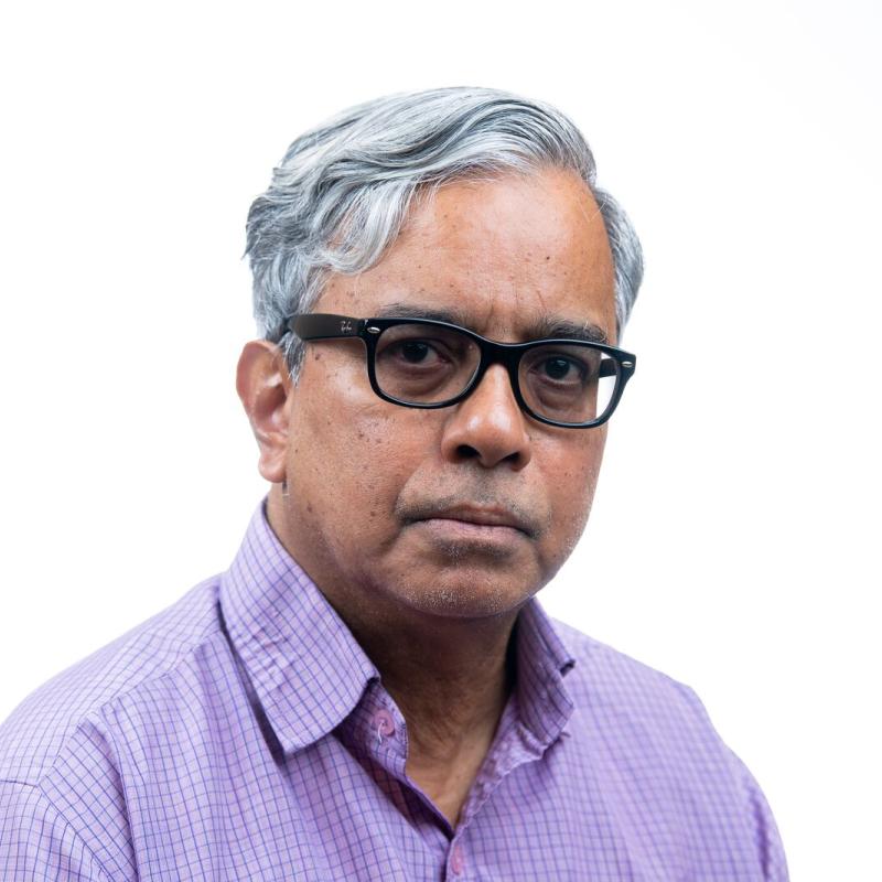 Photo of a man in a purple shirt. 