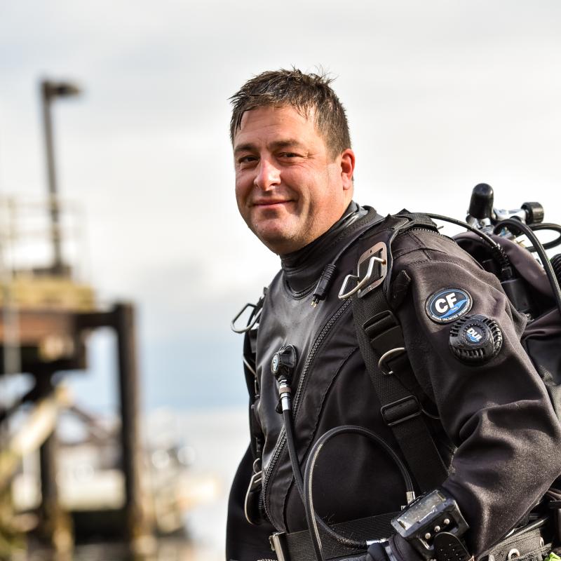 Photo of John Vavrinec in a dive suit.