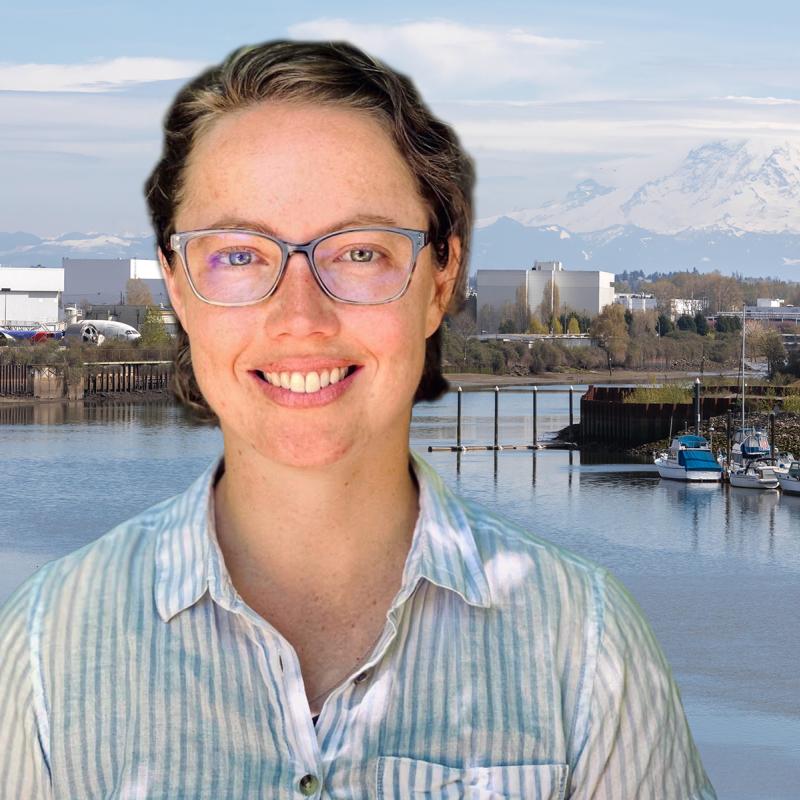 Oceanographer Maggie McKeon with a background of Mt Rainer and the Duwamish River, where she did her research.