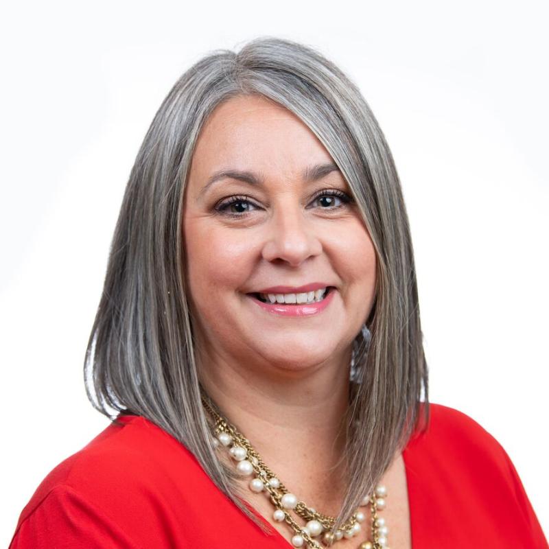 lady in red shirt with necklace.