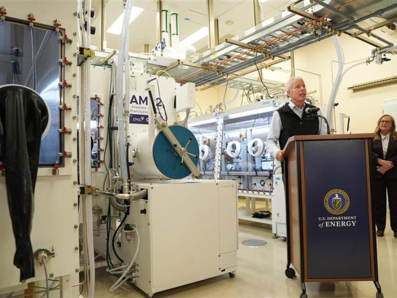 Secretary of Energy Chris Wright speaks at a podium in front of the AMP2 equipment room