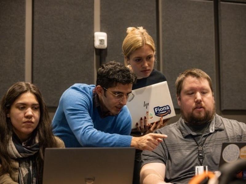 PNNL Staff looking at laptops and working through computing challenges