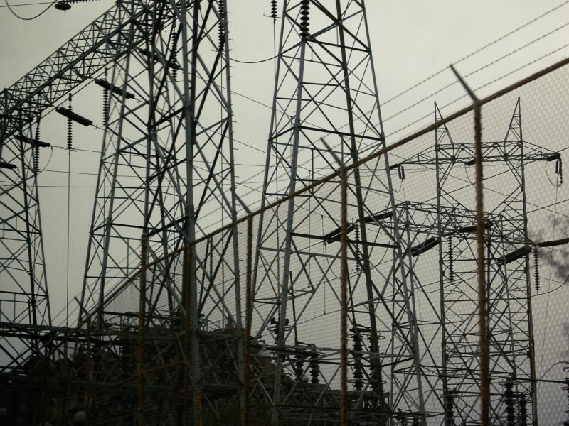 Power lines in front of a gray sky