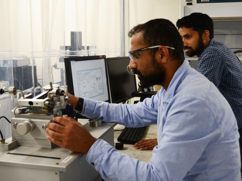 Two researchers using instrument