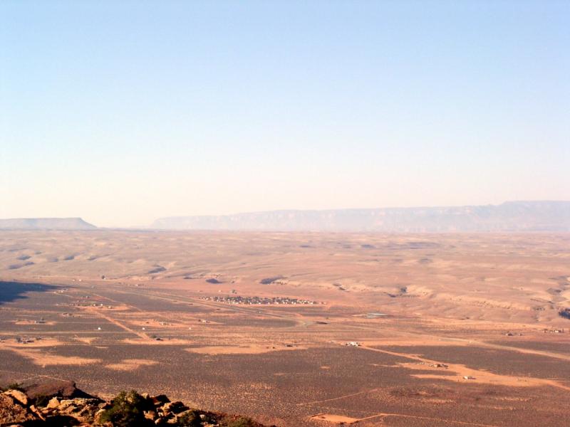 Photograph of dry, brown landscape with a blue sky above