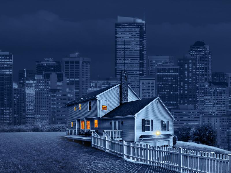 Blue scale composite image of a house with a city skyline in the background