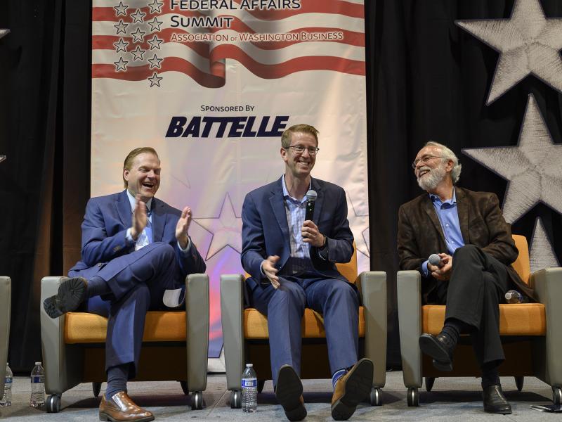 AWB President and CEO Kris Johnson, Congressman Derek Kilmer, and Congressman Dan Newhouse seated on stage at the AWB Federal Affairs Summit at PNNL.