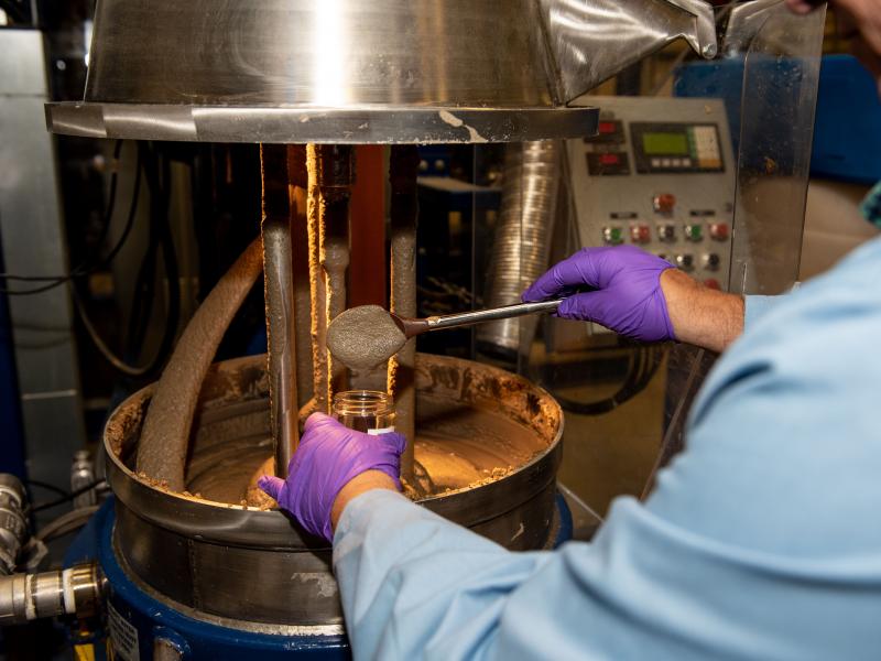 Picture of researcher scooping mush into a jar