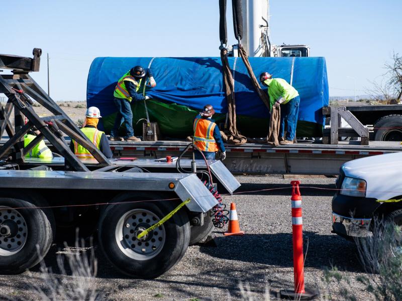 One of three spent nuclear fuel canisters arrives on a flatbed truck, ready for researchers to use the container in their research on nuclear fuel management.