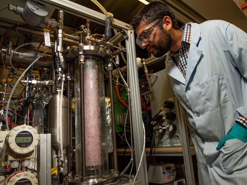 Chemical engineer Dushyant Barpaga observes the Laboratory Continuous Flow System, which researchers use to analyze the performance of CO2 capture solvents, like EEMPA, at small scales before testing at greater capacities.