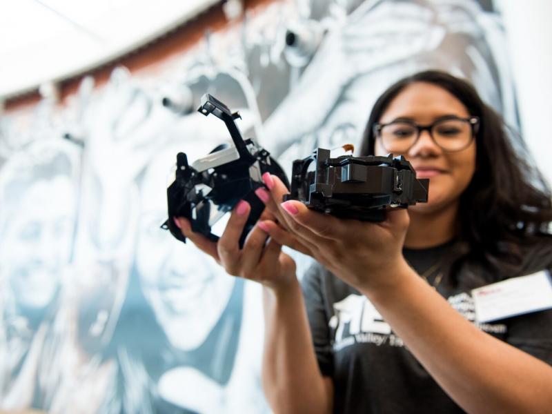 A student holding machinery