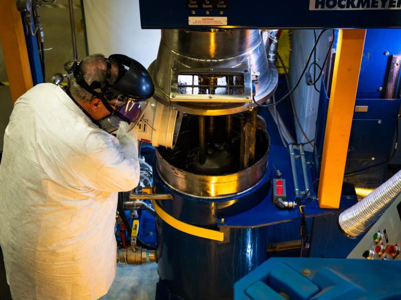 Man pouring waste into a machine