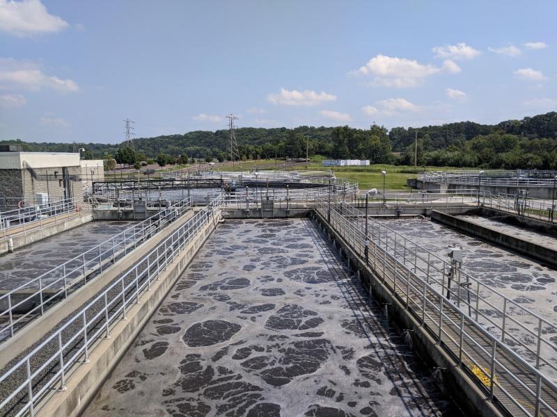 Water treatment plant with large outdoor tanks of frothy water