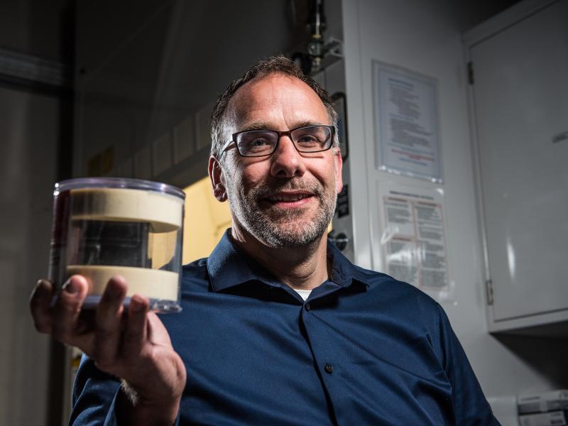 Nuclear forensics scientist Jon Schwantes holds up the uranium cube believed to be a Heisenberg Cube. 