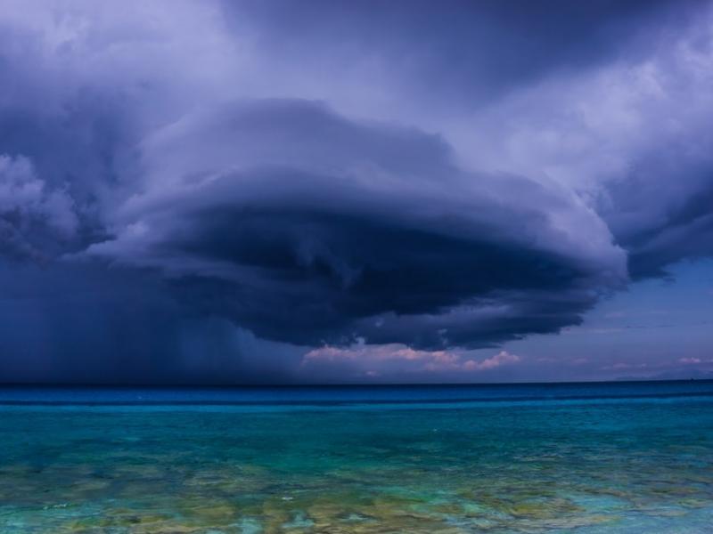 Dark ominous clouds over bright ocean