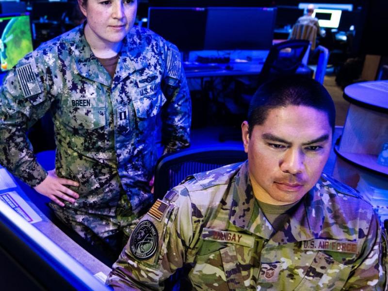 two people looking at computers