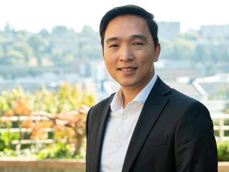 Photo of Loc Truong with Seattle in the background