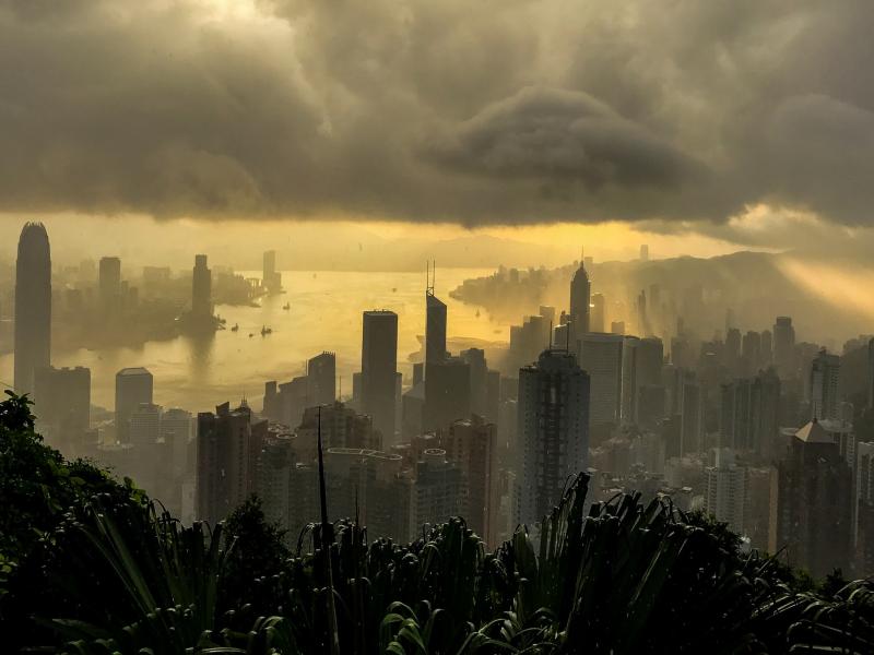 city skyline with rain clouds and yellow light
