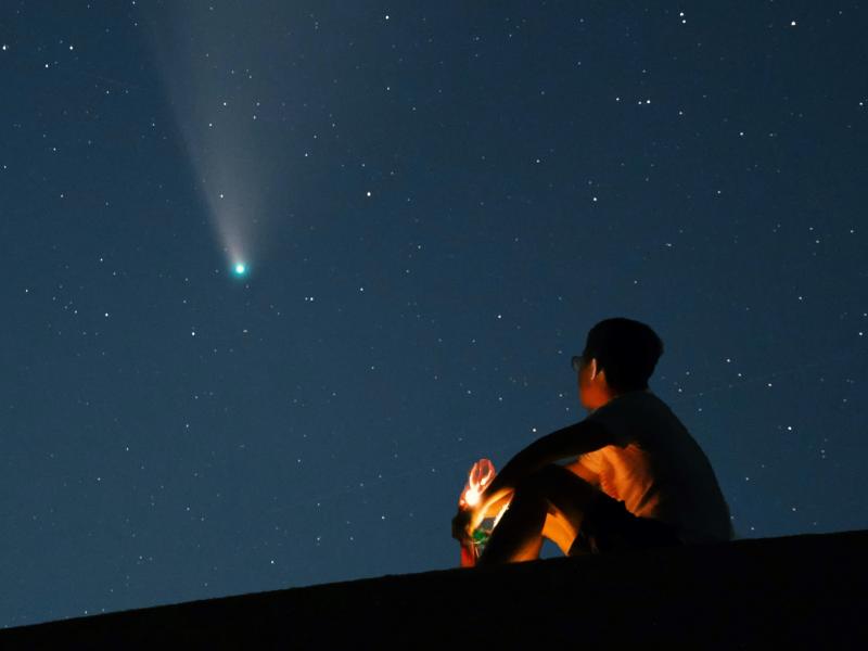 Person looking at a comet tail