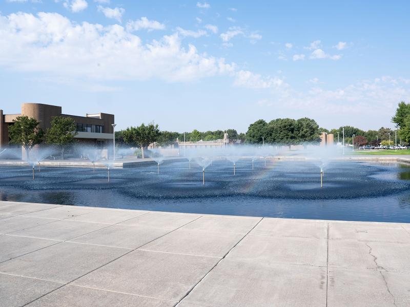 fountains in a large reflecting pool spraying water into the air