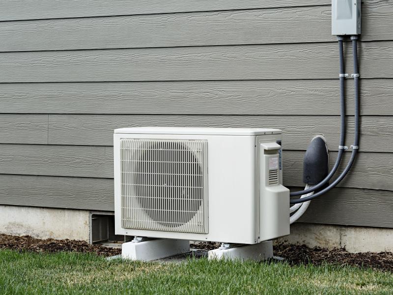 A ductless heat pump installed next to a house