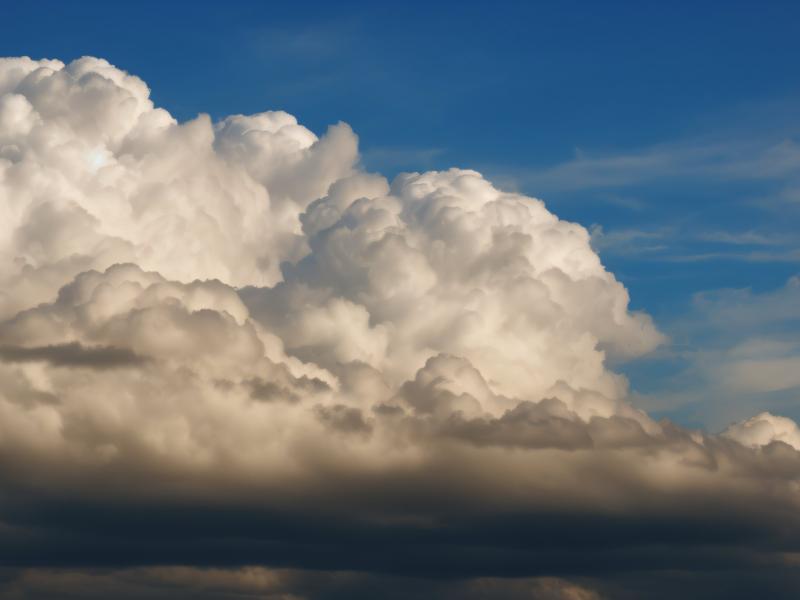 Gathering storm clouds with blue skies above