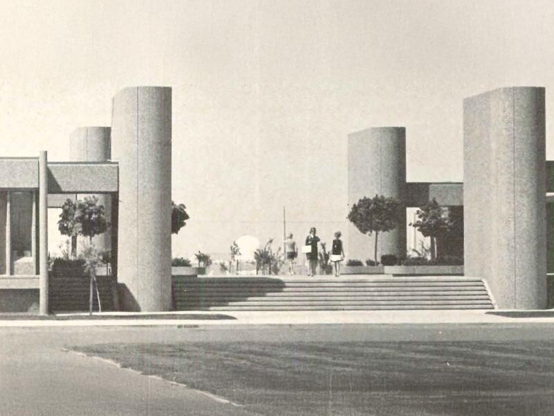 archival black and white photo of cylindrical tower-like buildings around a concrete plaza