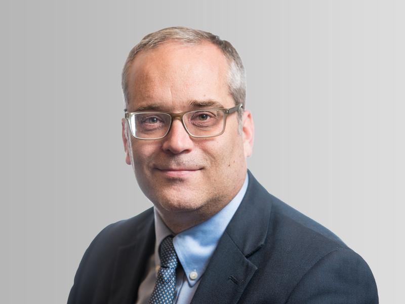 Man in glasses and suit smiling