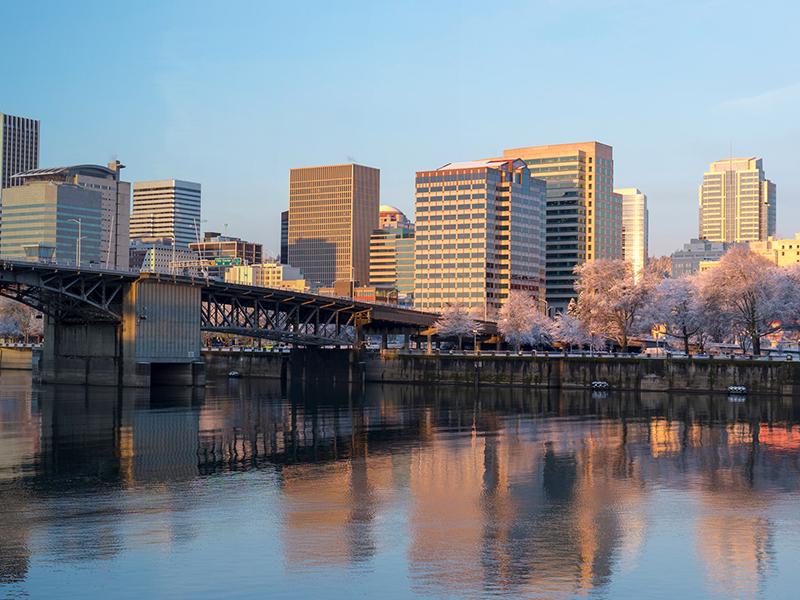 The portland skyline with the Morrison Bridge and Wilamette river in the foreground