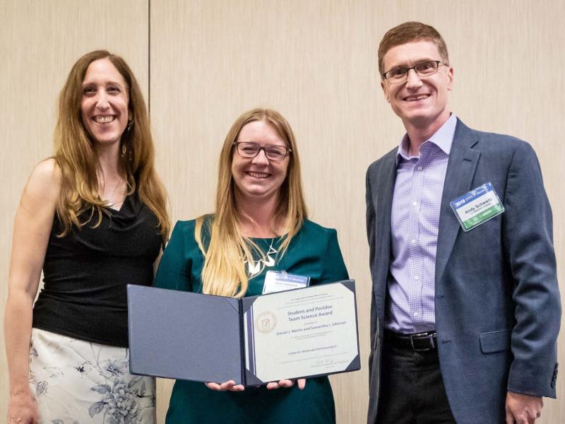 Samantha Johnson (center) receives a team science award from Dr. Robin Hayes, program manager for EFRCs (left), and Dr. Andy Schwartz, senior technical advisor and team lead of EFRCs (right).