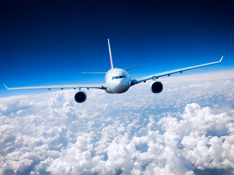 Airplane flying above clouds