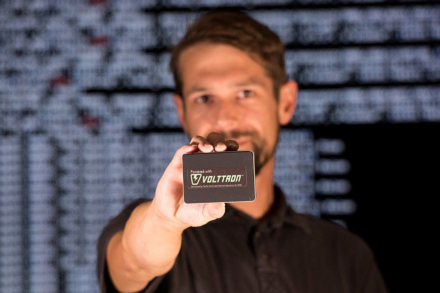 A researcher holds a VOLTTRON device toward the camera