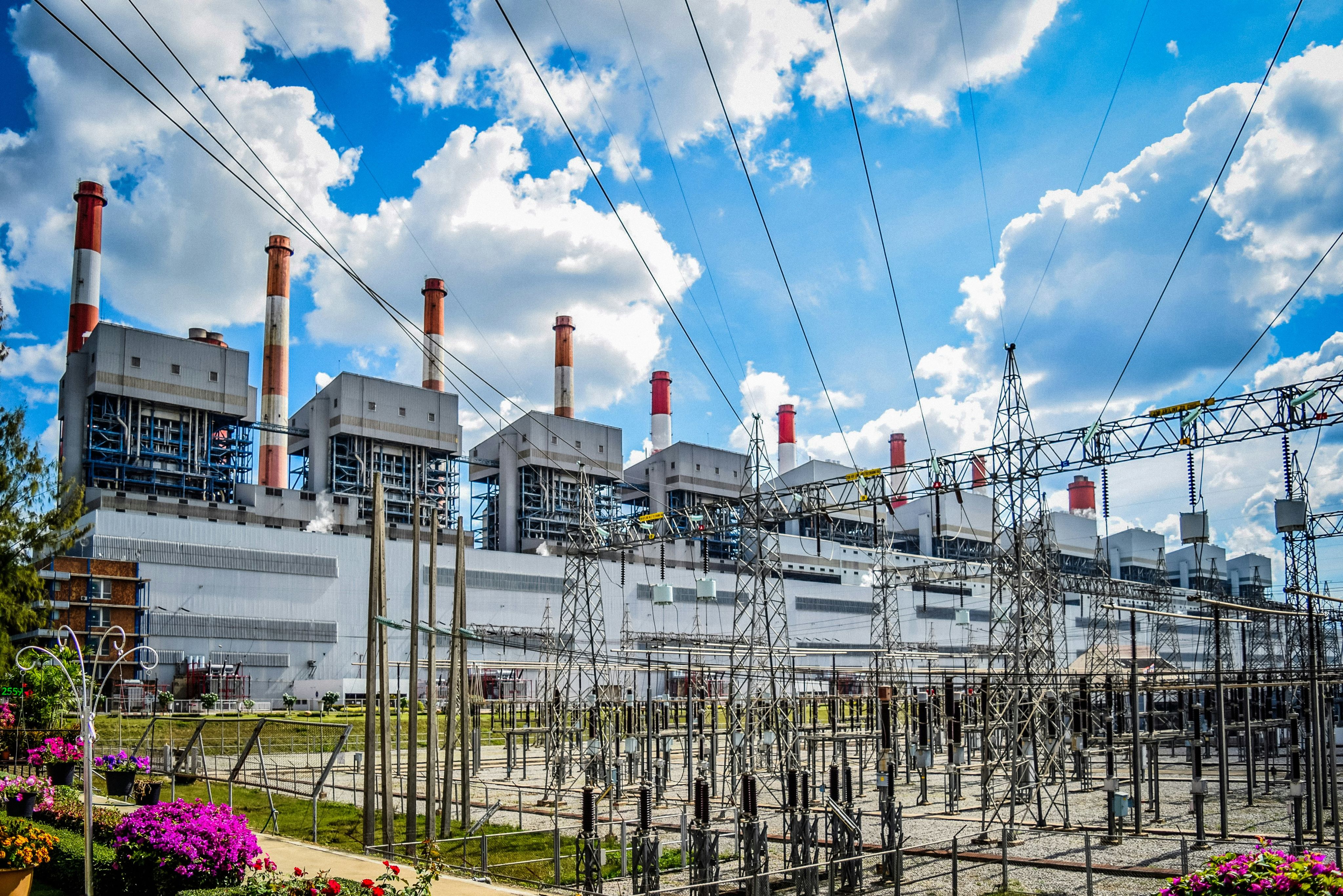A power plant with lots of power lines in front of it